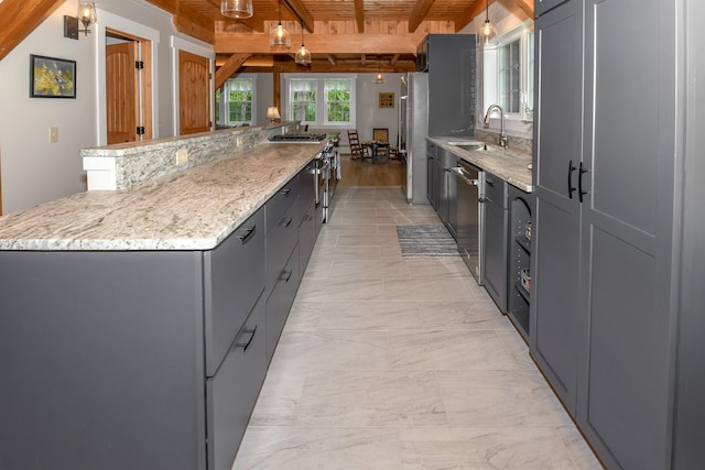 689 Hard Scrabble Rd, Sweden, ME 04008 - kitchen with a large island, wood ceiling with exposed beams, stainless steel appliances, a sink, and light stone counters