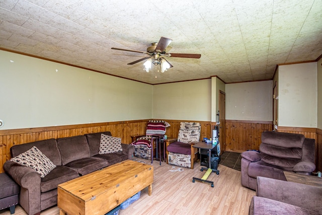 1351 Bobbin Mill Rd, Lunenburg, VT 05906 - living room with a wainscoted wall, ornamental molding, wood finished floors, a ceiling fan, and wood walls