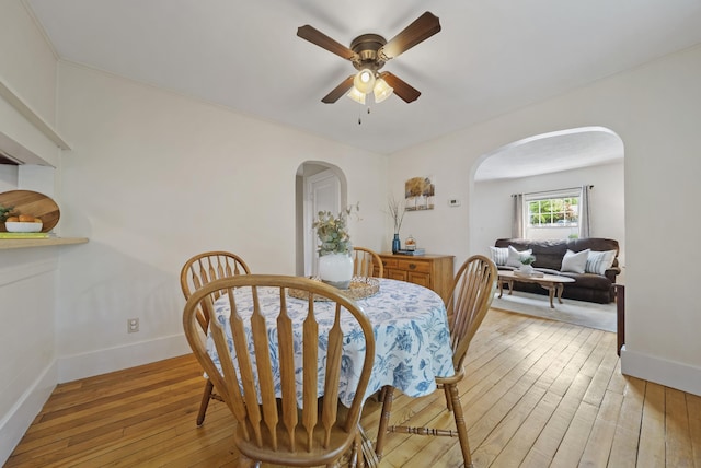 16 Ann Ave, Salem, NH 03079 - dining room with arched walkways, light wood finished floors, ceiling fan, and baseboards