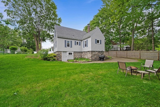 16 Ann Ave, Salem, NH 03079 - rear view of property with a fire pit, a chimney, a shingled roof, and stone siding