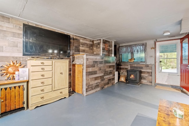 72 Beaver Rd, Strafford, NH 03884 - living room with a wood stove, wood walls, and finished concrete floors