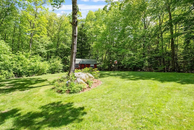 72 Beaver Rd, Strafford, NH 03884 - view of green lawn featuring a forest view and an outbuilding