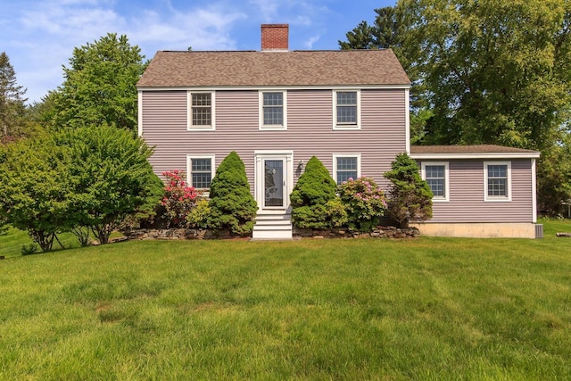 19 Cambridge Rd, Hampstead, NH 03841 - colonial house with a chimney, a front lawn, and roof with shingles