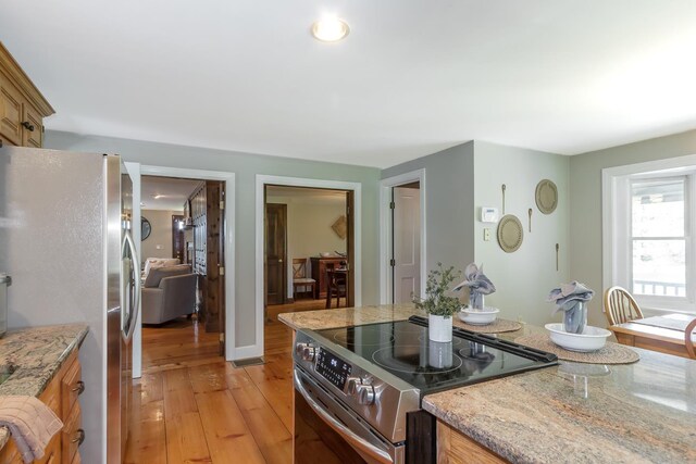 19 Cambridge Rd, Hampstead, NH 03841 - kitchen with appliances with stainless steel finishes, light wood finished floors, and light stone counters