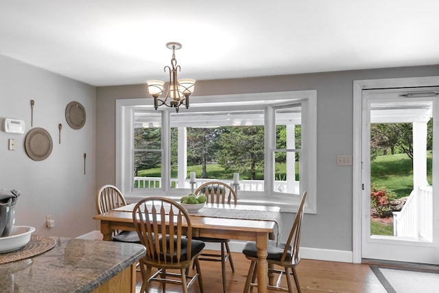 19 Cambridge Rd, Hampstead, NH 03841 - dining area featuring light wood-style floors, a chandelier, and baseboards