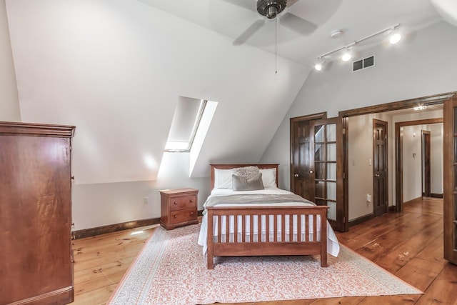 19 Cambridge Rd, Hampstead, NH 03841 - bedroom with vaulted ceiling, wood-type flooring, a skylight, rail lighting, and baseboards