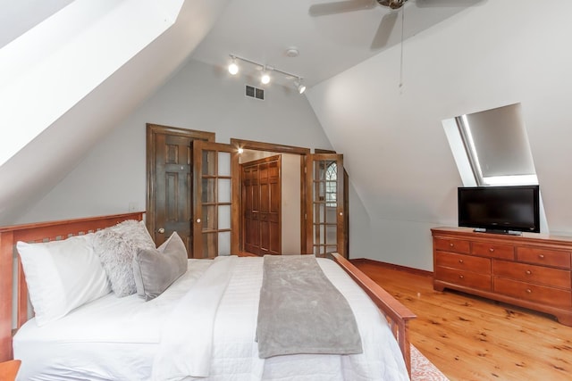 19 Cambridge Rd, Hampstead, NH 03841 - bedroom with light wood-type flooring, vaulted ceiling, a skylight, and ceiling fan
