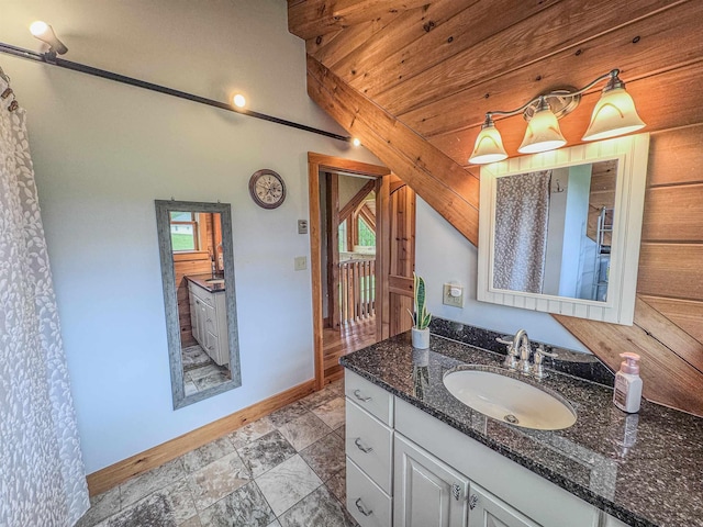 93 Rowell Hill Rd, New London, NH 03257 - full bathroom with lofted ceiling, baseboards, and vanity