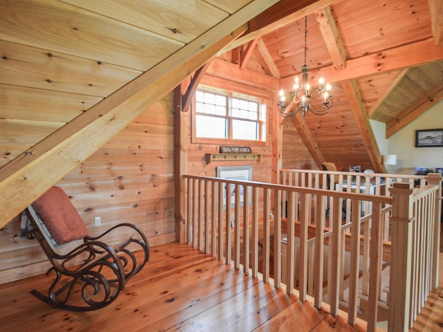 93 Rowell Hill Rd, New London, NH 03257 - unfurnished room with a chandelier, wood ceiling, an upstairs landing, hardwood / wood-style flooring, and wood walls