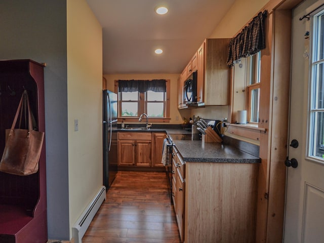 93 Rowell Hill Rd, New London, NH 03257 - kitchen with a baseboard heating unit, black microwave, dark wood finished floors, dark countertops, and freestanding refrigerator