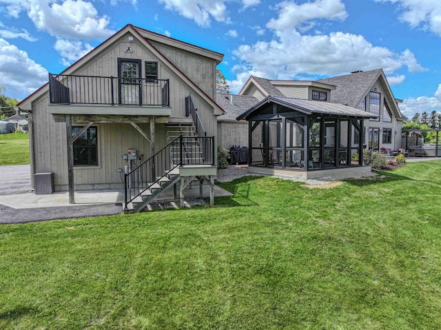 93 Rowell Hill Rd, New London, NH 03257 - rear view of house with stairs, a sunroom, a lawn, and a patio