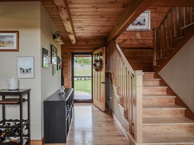 93 Rowell Hill Rd, New London, NH 03257 - foyer entrance featuring light wood finished floors, stairs, wood ceiling, and wooden walls