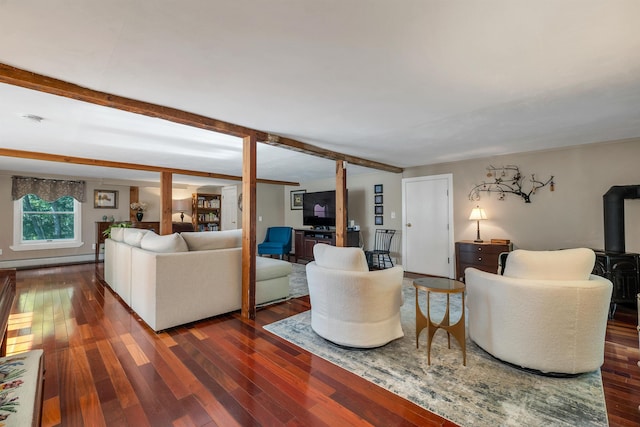 92 Mace Rd, Hampton, NH 03842 - living area with dark wood finished floors, a wood stove, beam ceiling, and baseboard heating