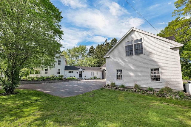 92 Mace Rd, Hampton, NH 03842 - back of property with driveway, a lawn, and a garage