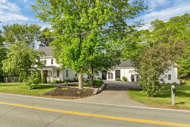 92 Mace Rd, Hampton, NH 03842 - view of property hidden behind natural elements with a front lawn, french doors, and asphalt driveway
