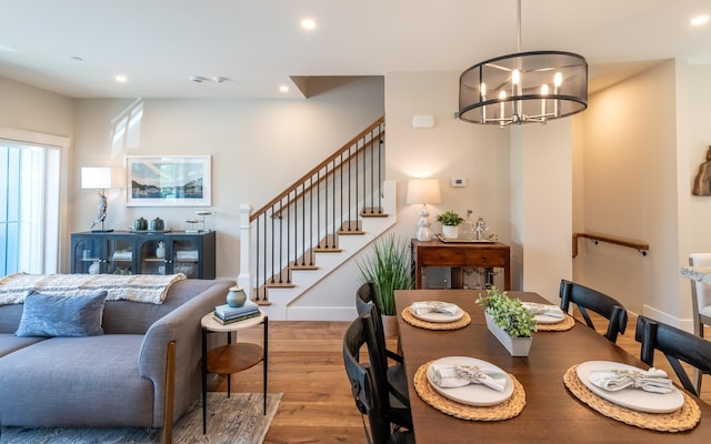 60 White Oaks Rd Unit 26, Laconia, NH 03246 - dining room featuring wood finished floors, a chandelier, recessed lighting, stairway, and baseboards