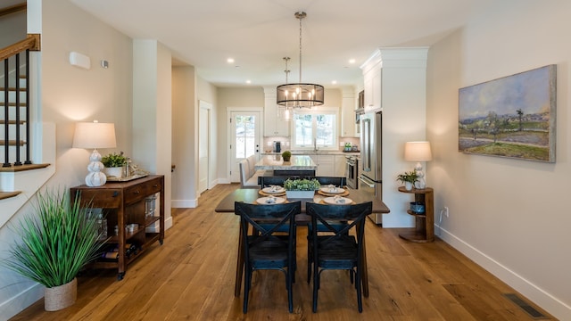 60 White Oaks Rd Unit 26, Laconia, NH 03246 - dining area featuring baseboards, wood finished floors, a chandelier, and recessed lighting