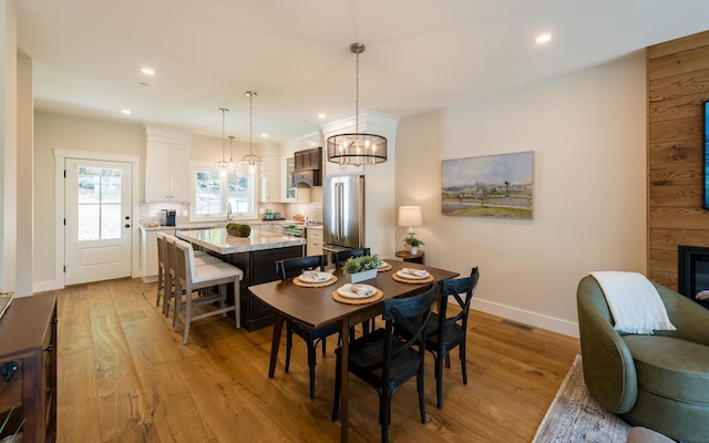 60 White Oaks Rd Unit 26, Laconia, NH 03246 - dining space featuring light wood-style flooring, baseboards, recessed lighting, and a chandelier