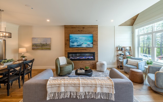 60 White Oaks Rd Unit 26, Laconia, NH 03246 - living area featuring a large fireplace, wood finished floors, baseboards, a chandelier, and recessed lighting