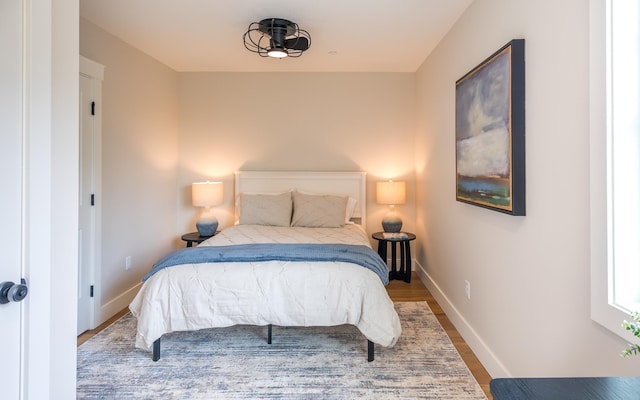 60 White Oaks Rd Unit 26, Laconia, NH 03246 - bedroom with baseboards and wood finished floors