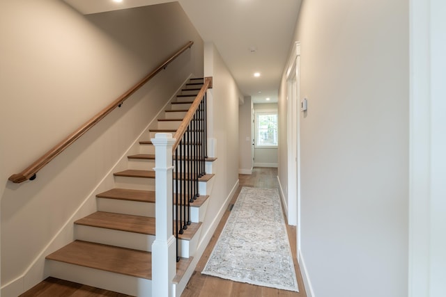 60 White Oaks Rd Unit 26, Laconia, NH 03246 - stairs featuring wood finished floors, recessed lighting, and baseboards