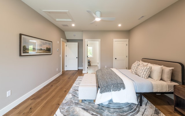 60 White Oaks Rd Unit 26, Laconia, NH 03246 - bedroom featuring light wood finished floors, attic access, baseboards, recessed lighting, and ensuite bath