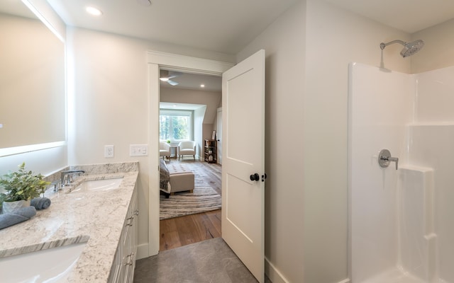 60 White Oaks Rd Unit 26, Laconia, NH 03246 - ensuite bathroom featuring double vanity, a shower, recessed lighting, and wood finished floors