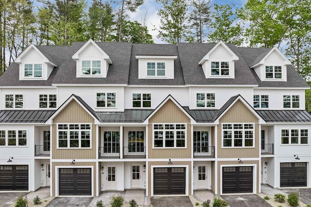 60 White Oaks Rd Unit 26, Laconia, NH 03246 - townhome / multi-family property with a standing seam roof, metal roof, driveway, and a garage