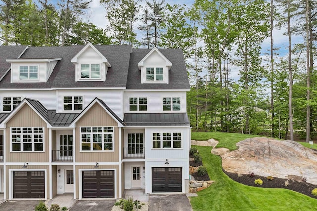 60 White Oaks Rd Unit 26, Laconia, NH 03246 - view of front of home with a standing seam roof, metal roof, a garage, driveway, and a front yard