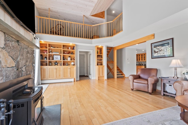 345 Williams Rd, Littleton, NH 03561 - living area featuring a high ceiling, stairway, a baseboard radiator, light wood-type flooring, and recessed lighting