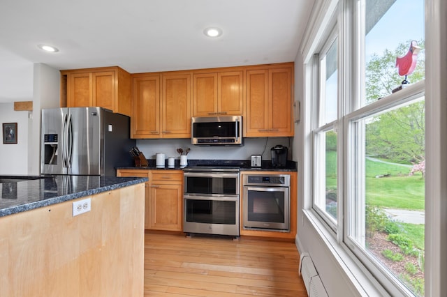 345 Williams Rd, Littleton, NH 03561 - kitchen featuring stainless steel appliances, recessed lighting, light wood-style flooring, dark stone countertops, and a baseboard radiator