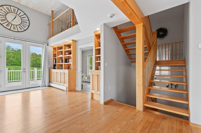 345 Williams Rd, Littleton, NH 03561 - staircase with hardwood / wood-style floors, built in shelves, french doors, and a high ceiling