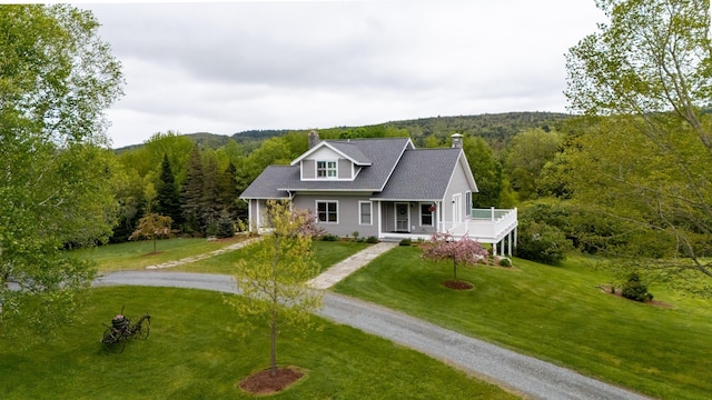 345 Williams Rd, Littleton, NH 03561 - view of front of home with dirt driveway, a view of trees, a chimney, and covered porch