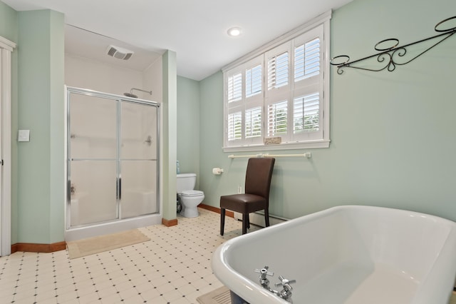 345 Williams Rd, Littleton, NH 03561 - bathroom featuring baseboards, toilet, a soaking tub, a stall shower, and recessed lighting