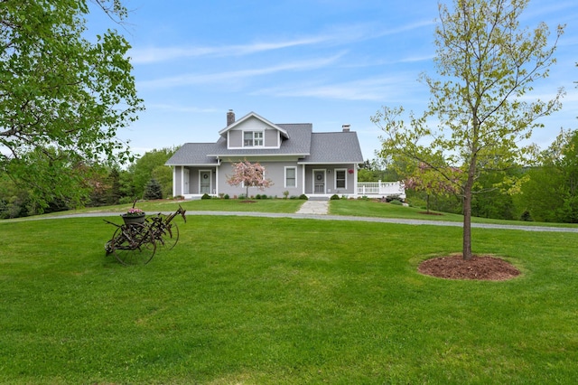 345 Williams Rd, Littleton, NH 03561 - view of front of house featuring a chimney, a front yard, a porch, and a shingled roof