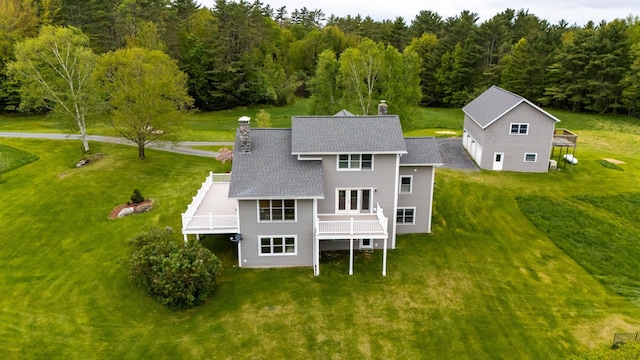 345 Williams Rd, Littleton, NH 03561 - back of property with a chimney, a forest view, roof with shingles, and a yard