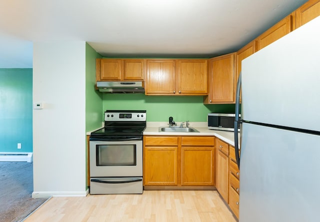 101 E Broadway Rd Unit 1, Derry, NH 03038 - kitchen featuring stainless steel appliances, under cabinet range hood, a sink, baseboard heating, and light countertops