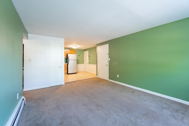 101 E Broadway Rd Unit 1, Derry, NH 03038 - spare room featuring baseboard heating, light colored carpet, and baseboards