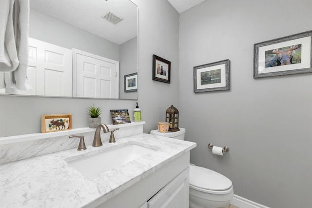 51 Cardinal Dr Unit B, Laconia, NH 03246 - bathroom featuring toilet, vanity, and baseboards