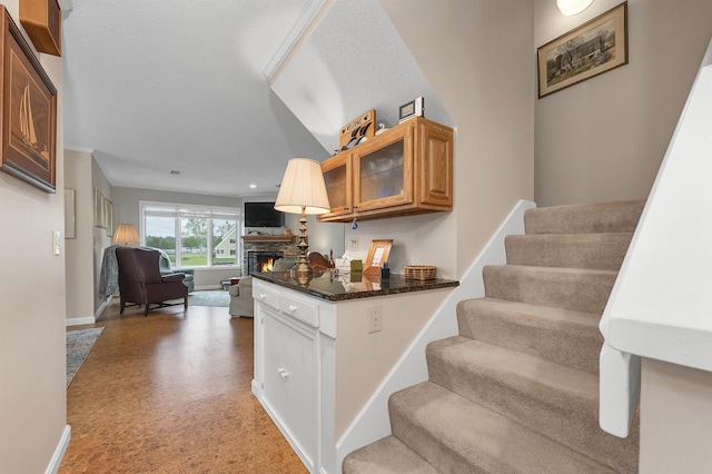 51 Cardinal Dr Unit B, Laconia, NH 03246 - kitchen featuring open floor plan, baseboards, glass insert cabinets, a stone fireplace, and recessed lighting