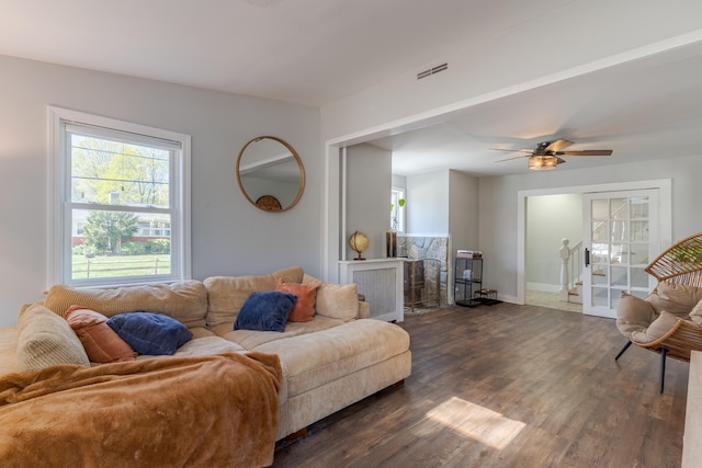 12 Harvard St, Exeter, NH 03862 - living area with dark wood finished floors, healthy amount of natural light, baseboards, and a ceiling fan