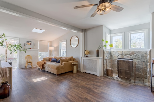 12 Harvard St, Exeter, NH 03862 - living room featuring a stone fireplace, wood finished floors, and plenty of natural light