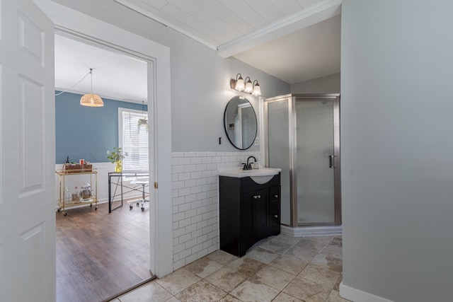 12 Harvard St, Exeter, NH 03862 - bathroom with vanity, a stall shower, a wainscoted wall, and tile walls