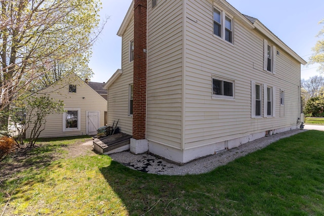 12 Harvard St, Exeter, NH 03862 - view of side of property featuring a lawn and a chimney