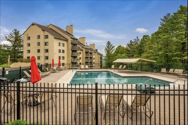 137 E Mountain Rd Unit 2E1, Killington, VT 05751 - community pool featuring a patio