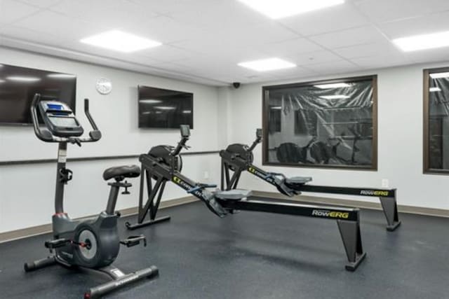 137 E Mountain Rd Unit 2E1, Killington, VT 05751 - exercise room with a paneled ceiling and baseboards