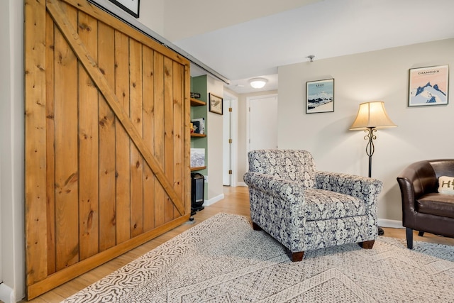 137 E Mountain Rd Unit 2E1, Killington, VT 05751 - living area with a barn door, light wood-style flooring, and baseboards