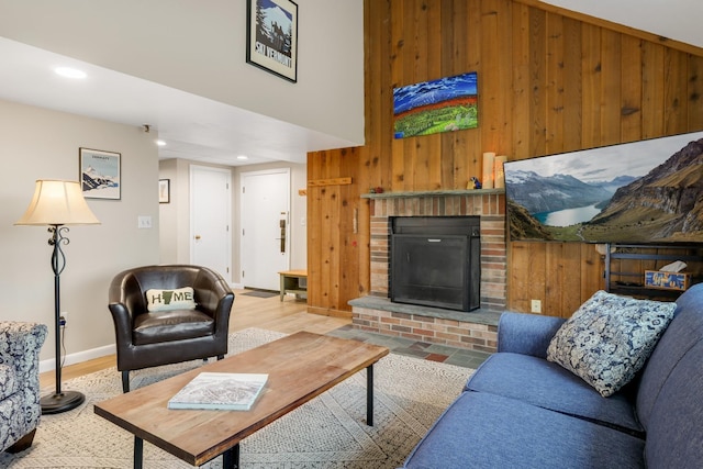 137 E Mountain Rd Unit 2E1, Killington, VT 05751 - living area with wooden walls, a brick fireplace, wood finished floors, recessed lighting, and baseboards