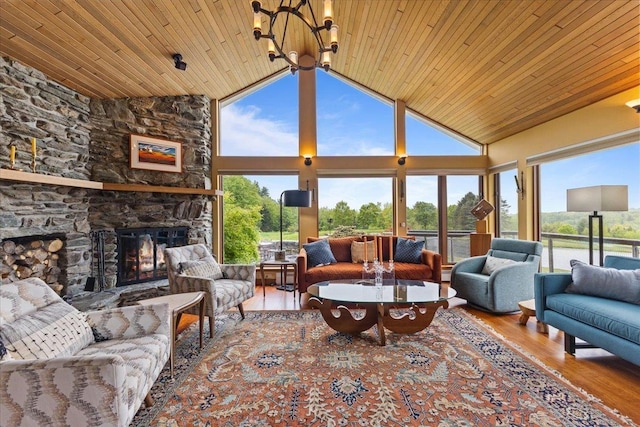 83 Dewey Farm Rd, Stowe, VT 05672 - living area featuring lofted ceiling, wood ceiling, wood finished floors, a fireplace, and a chandelier