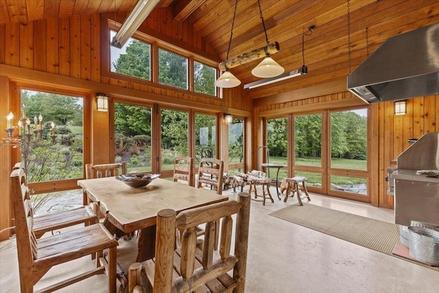 83 Dewey Farm Rd, Stowe, VT 05672 - sunroom with wooden ceiling with exposed beams, wood walls, high vaulted ceiling, concrete flooring, and french doors